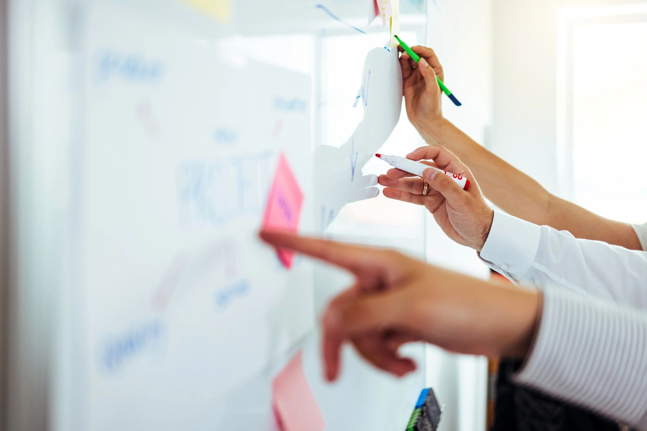 Consultant presenting strategy notes on a whiteboard