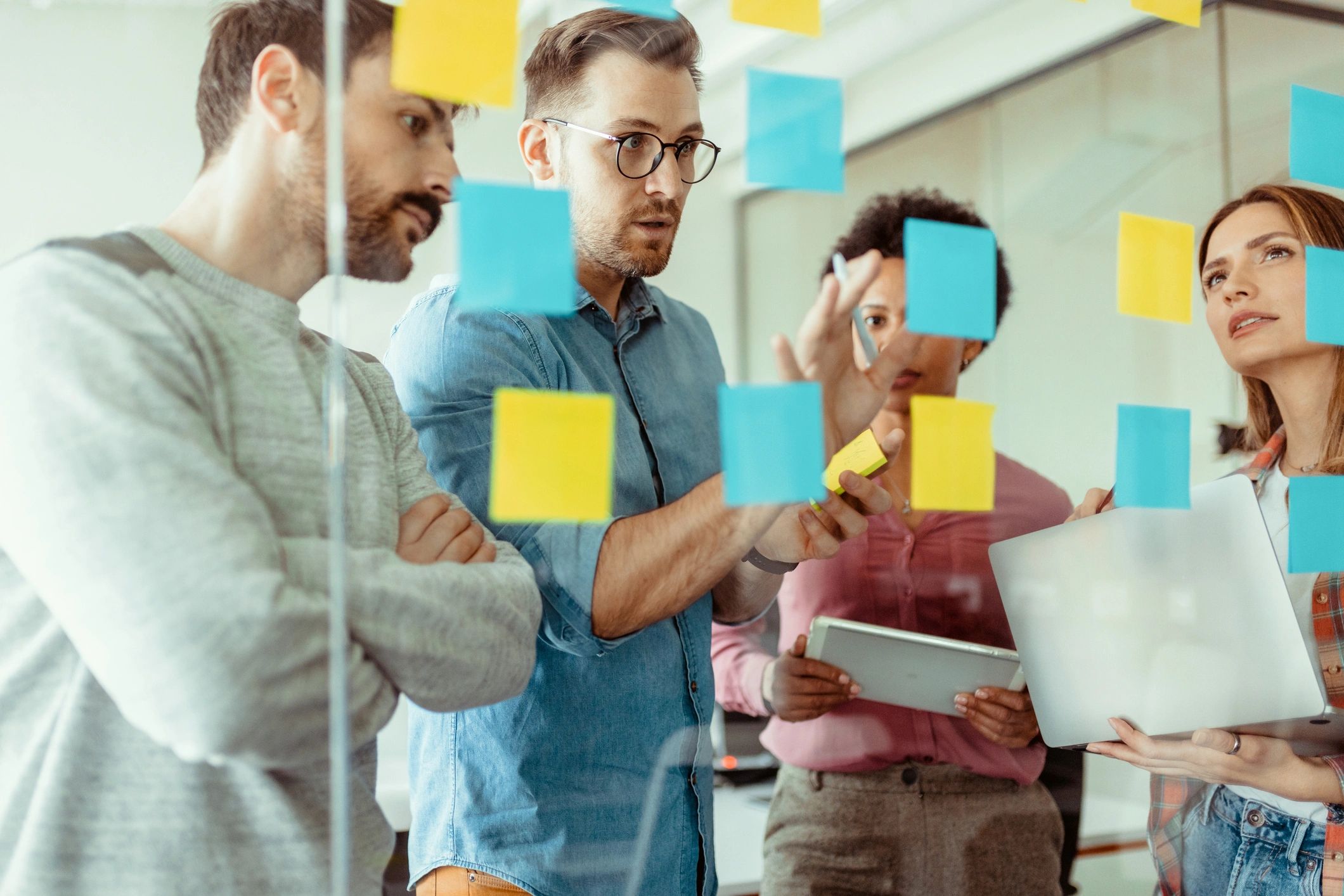 Team planning a product roadmap with sticky notes in a meeting