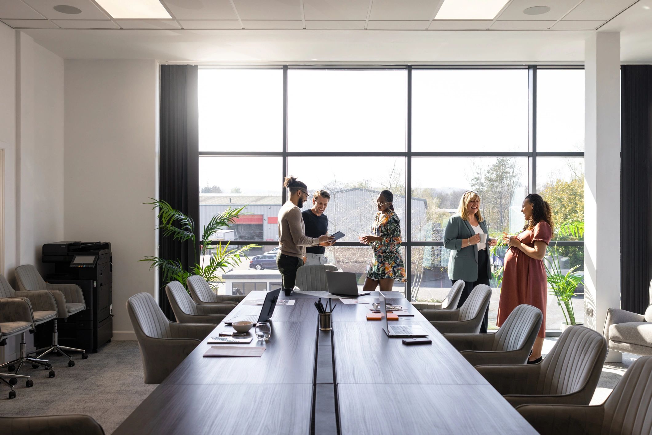 Colleagues discussing product strategy in a modern office